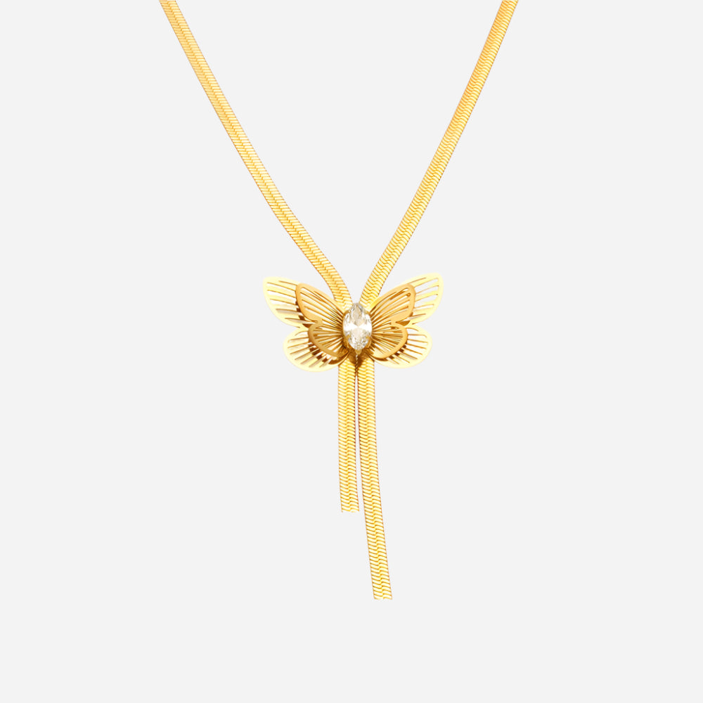 Gold butterfly necklace with a pearl center on a white background
