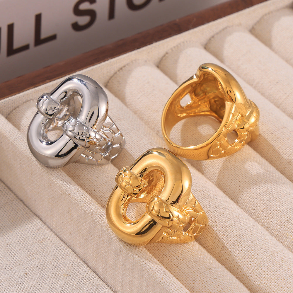 Two adjustable rings in gold and silver on beige fabric surface – minimalist statement jewelry