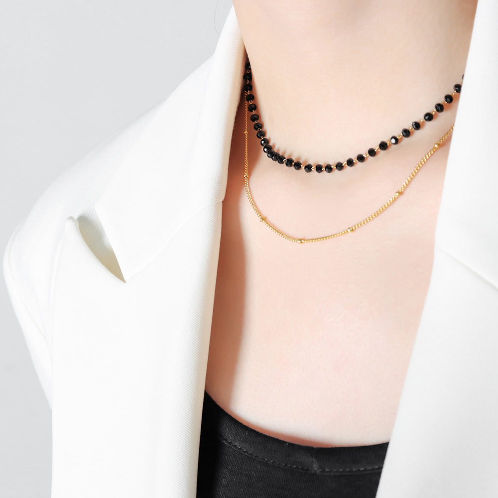Model wearing black sea glass necklace with double-layer design
