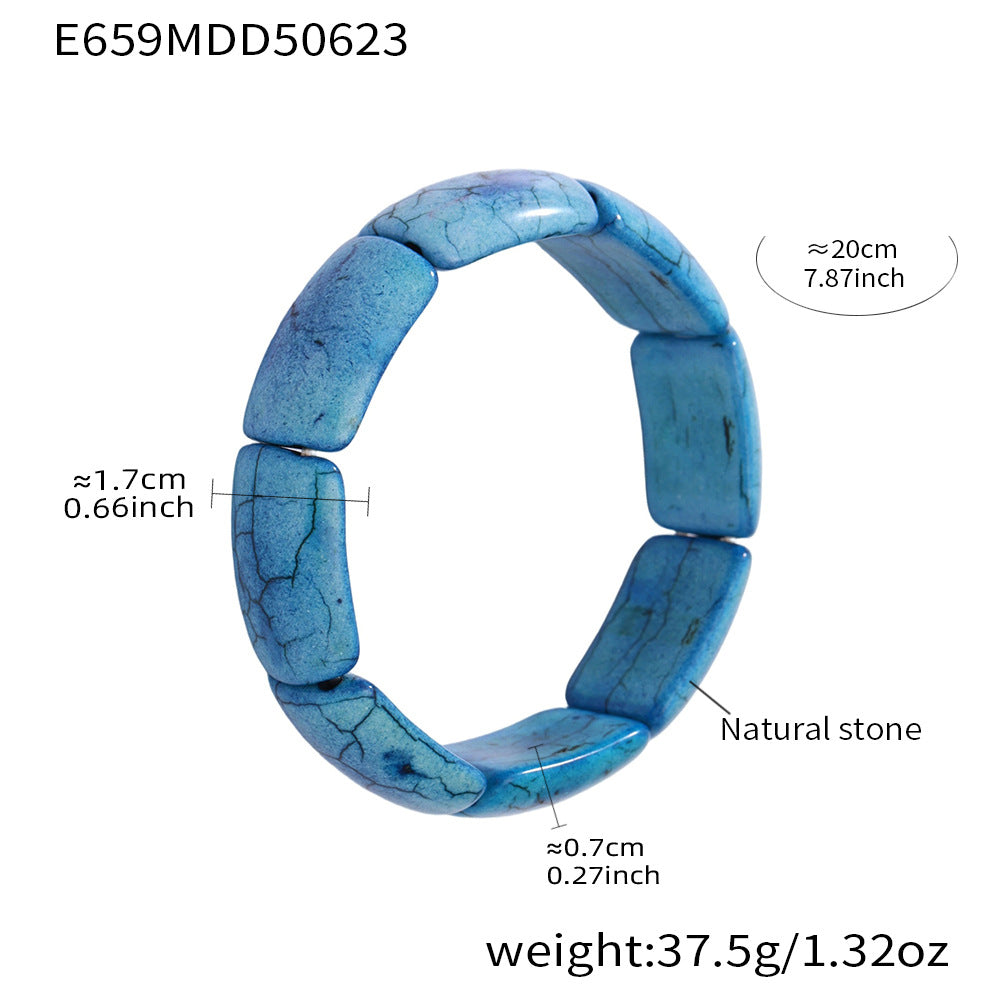 Blue stone tennis bracelet with stainless steel accents and size chart on white background