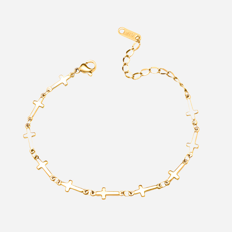 Gold bracelet with star and cross designs on a white background