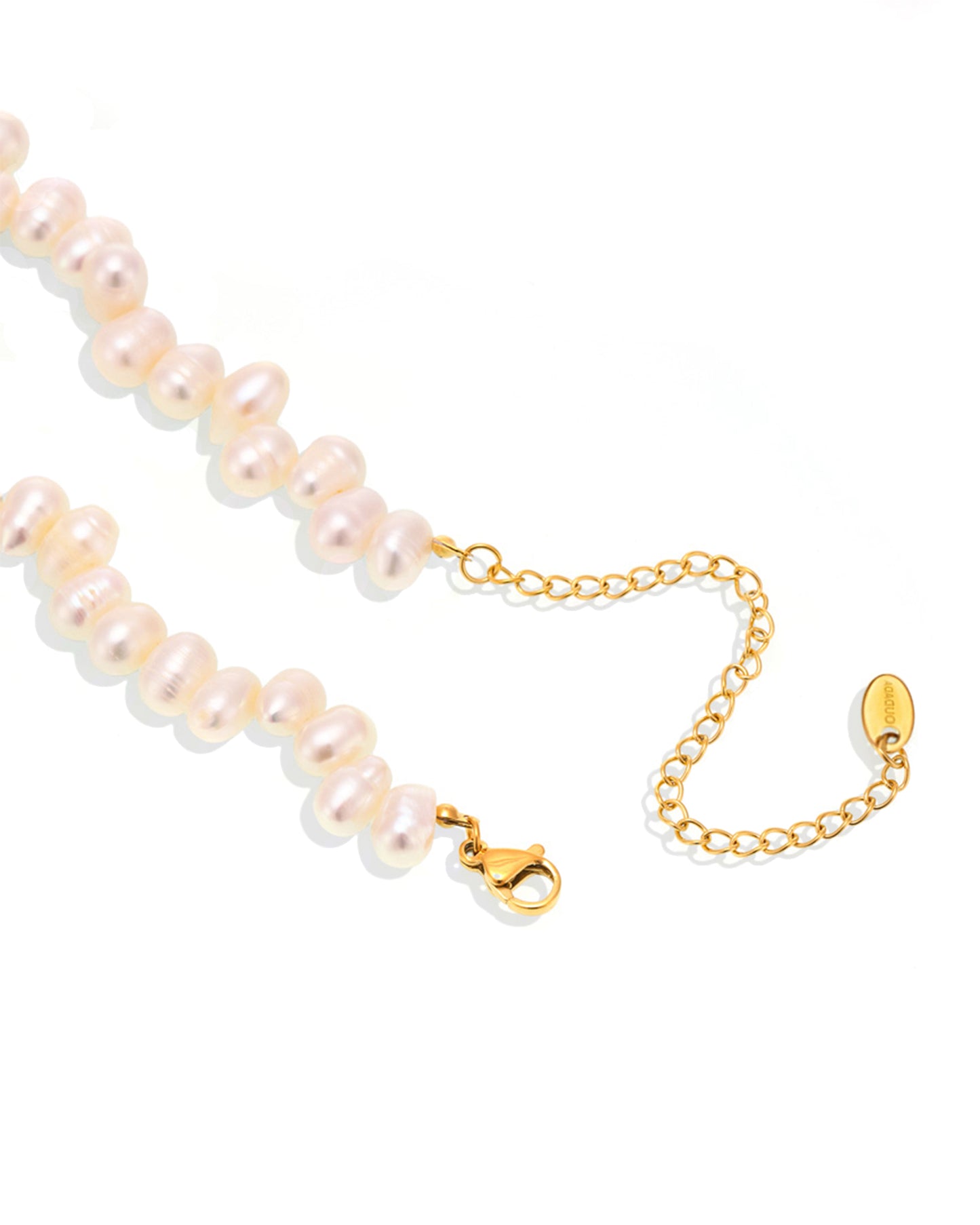 Close-up of baroque freshwater pearls and stainless steel chain details