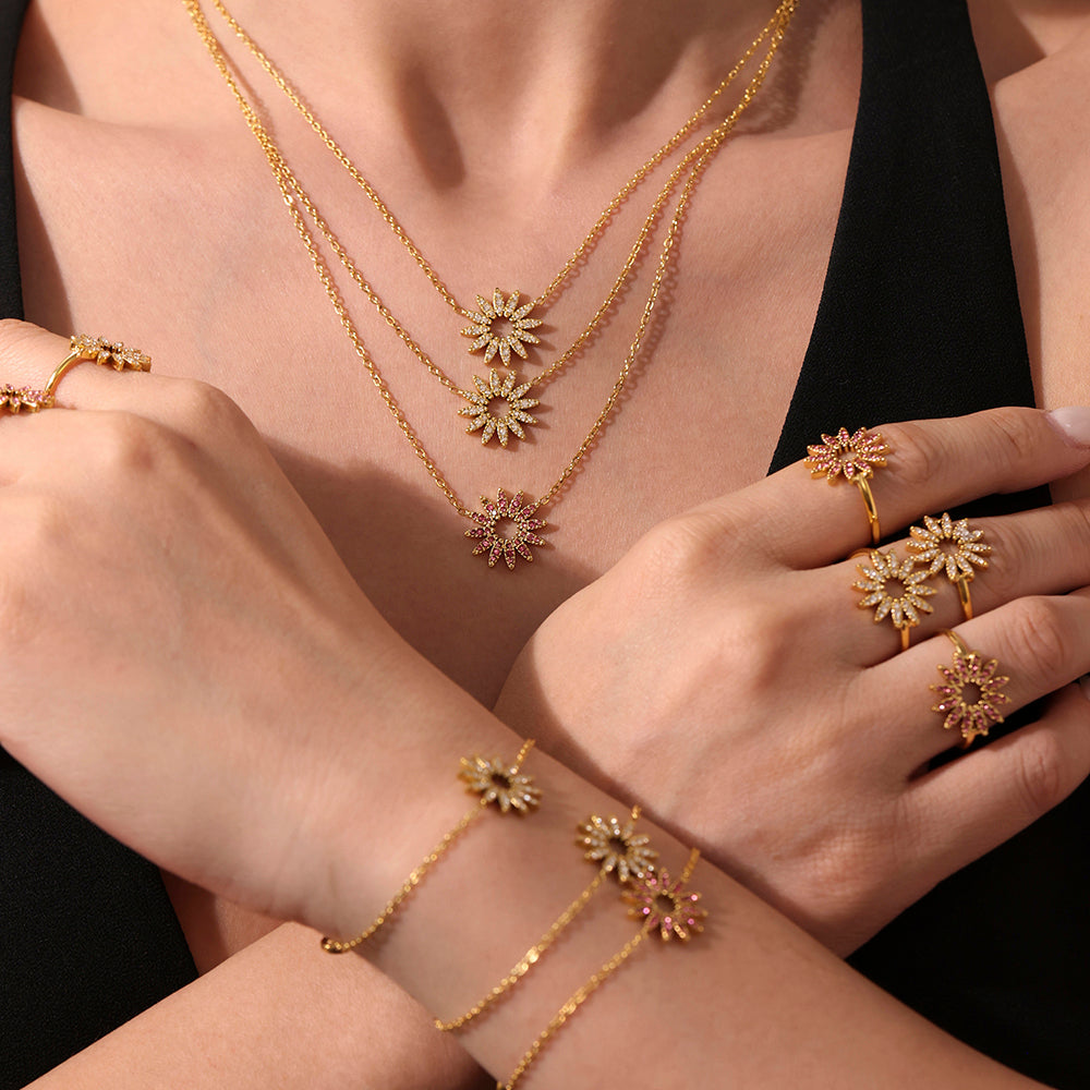 Gold tennis bracelet and matching jewelry set on wrist and hand