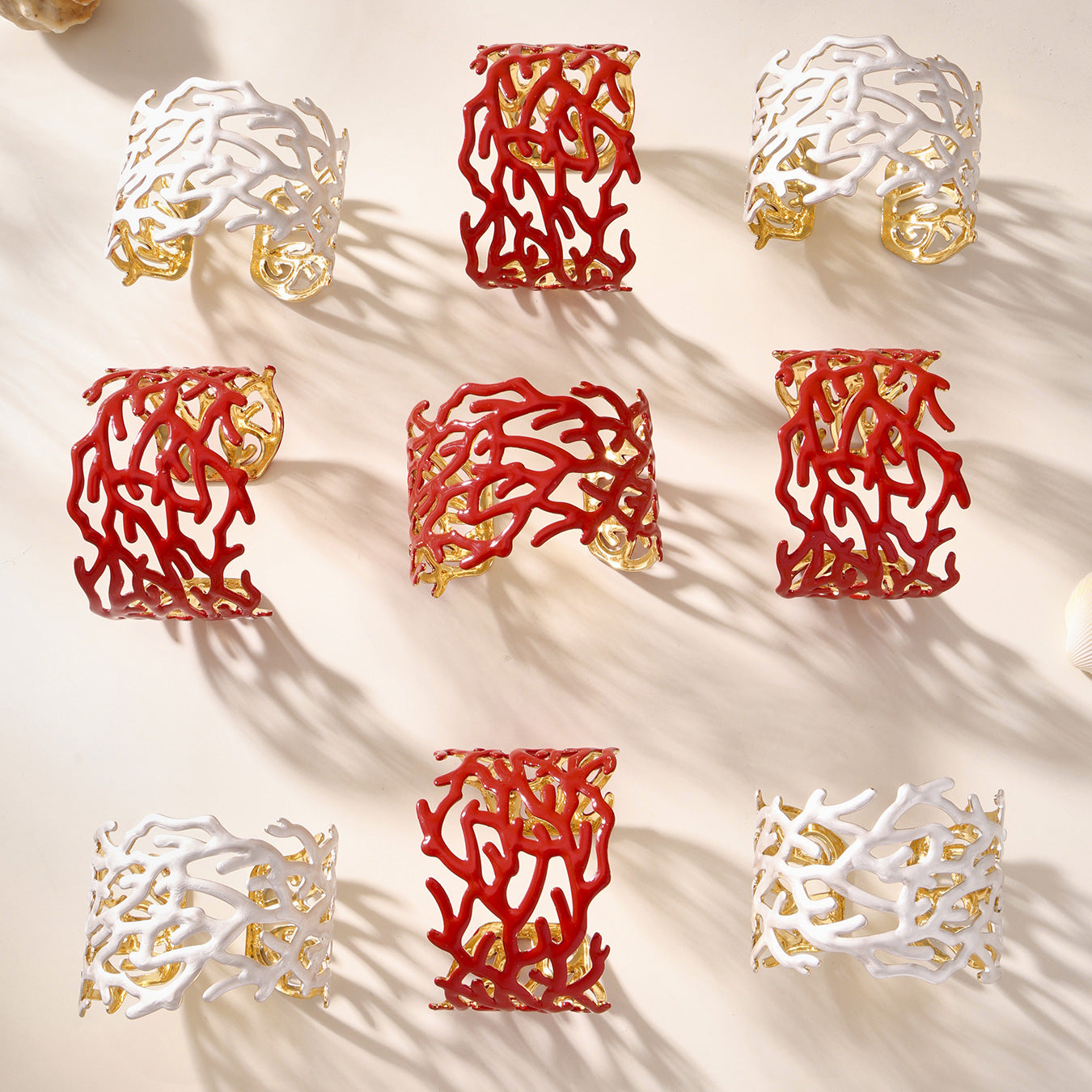 Coral-like decorative display featuring red and white stainless steel bangles on a beige background
