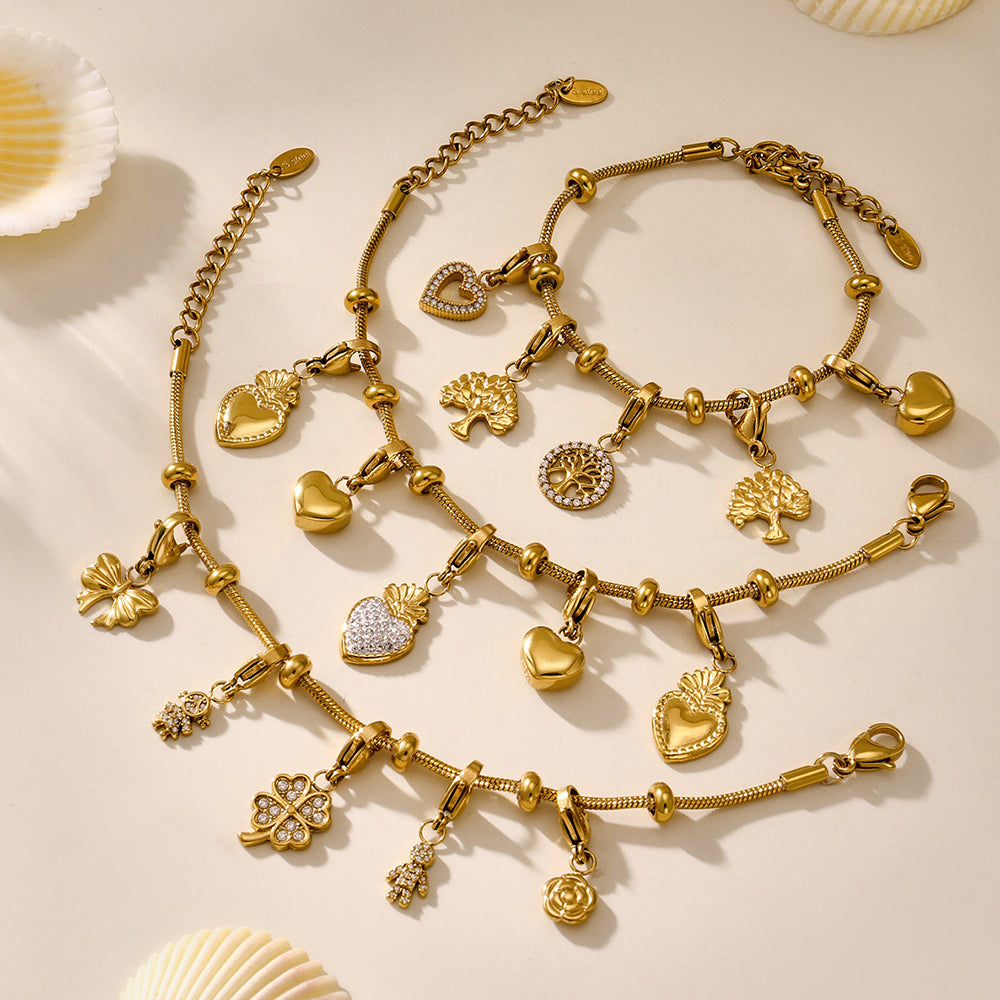 Interchangeable DIY gold charm bracelet kit displayed on a soft beige surface, featuring waterproof stainless steel and playful design.