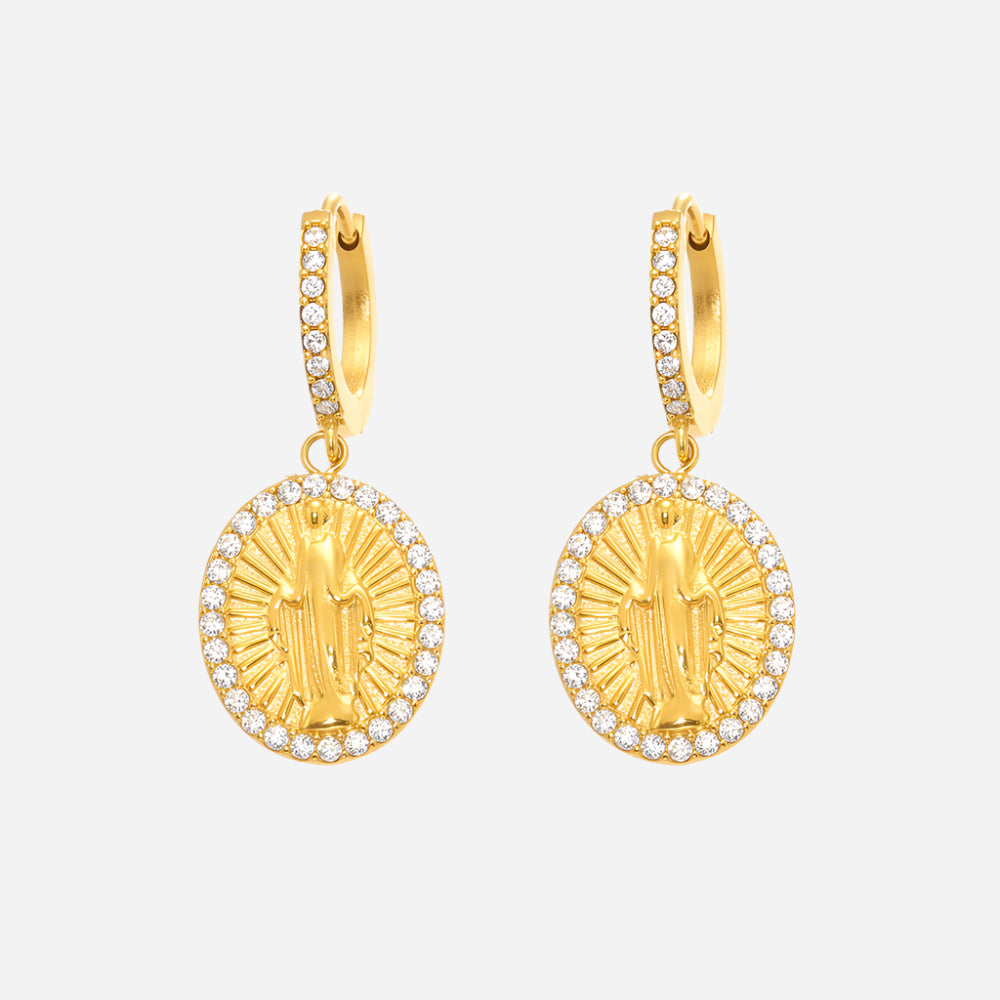 Gold earrings with religious design on a white background