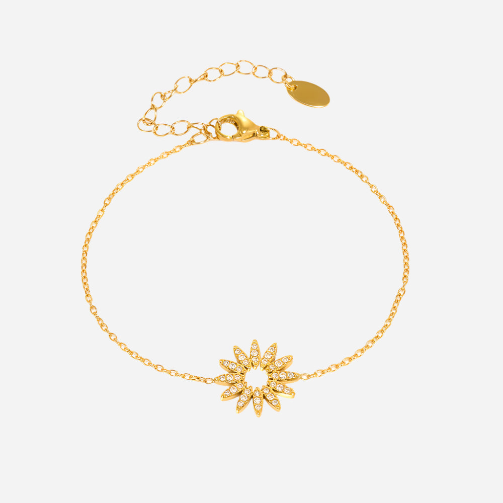 Gold sunflower tennis bracelet with zircon details on a light gray background