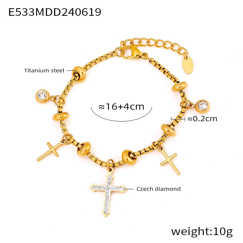 Gold stainless steel bracelet with cross charms and sizing guide on white background