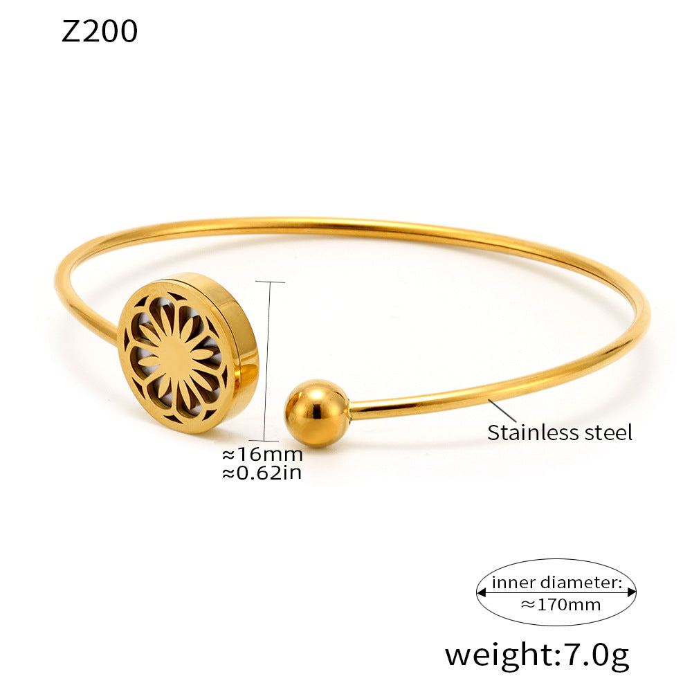 Gold adjustable bracelet with daisy charm displayed with measurements and weight on white background