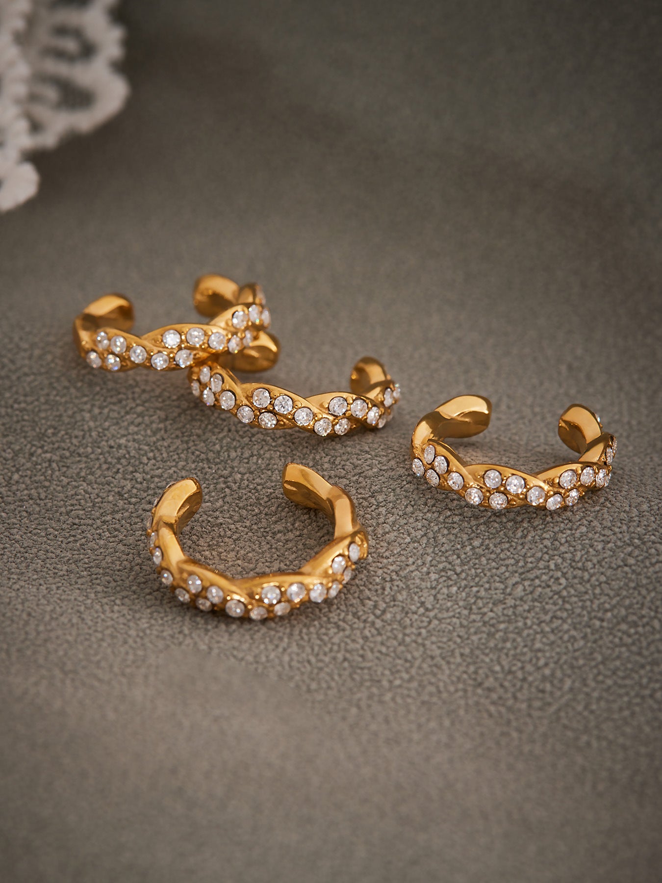 Close-up of 18K gold ear cuff showing opal zircon stone setting and smooth finish