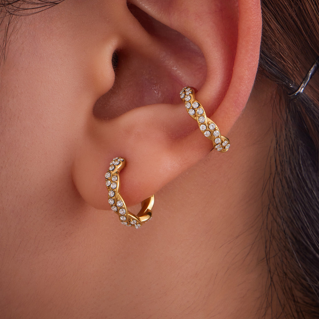 Model wearing gold ear cuff on cartilage, non piercing ear clip with zircon stones.
