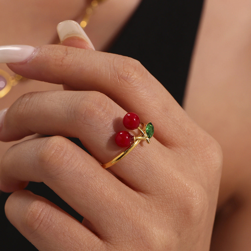 Hand modeling gold sea glass ring with red and green rhinestones