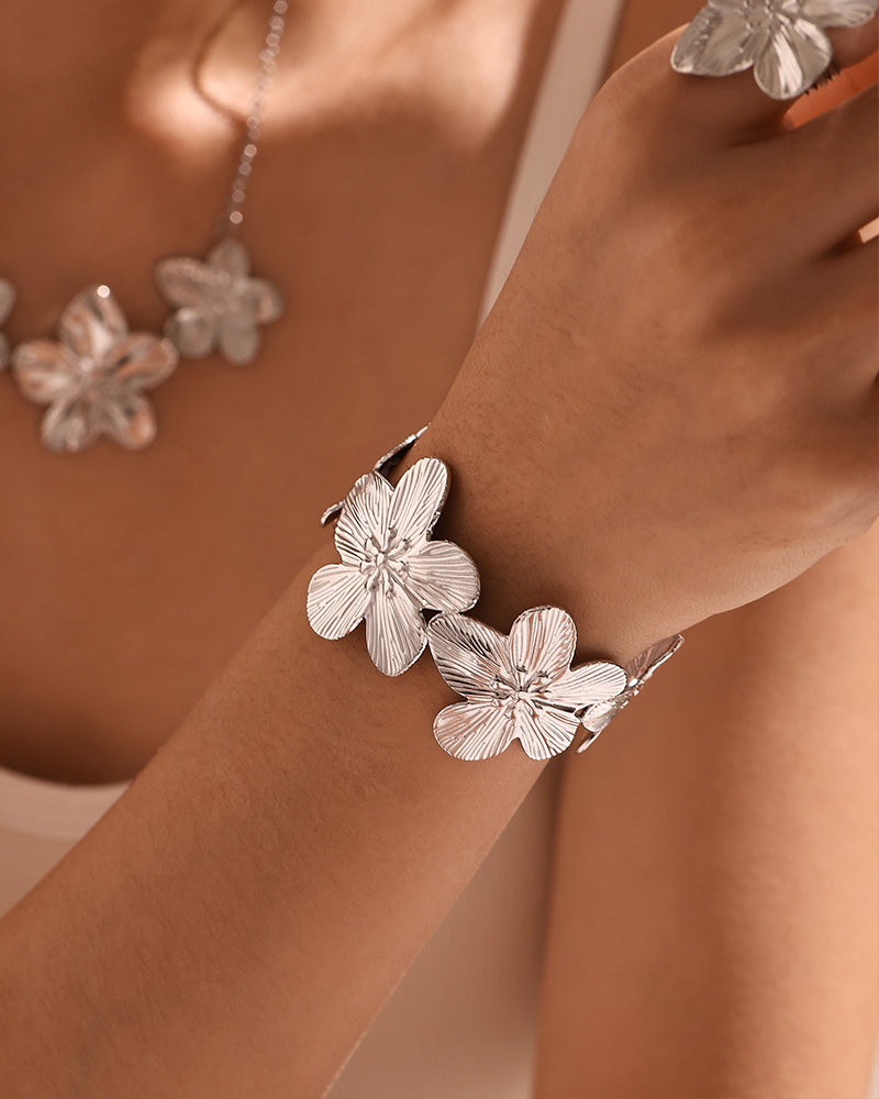 Close-up of Gold Flora Cuff Bracelet paired with layered bangles