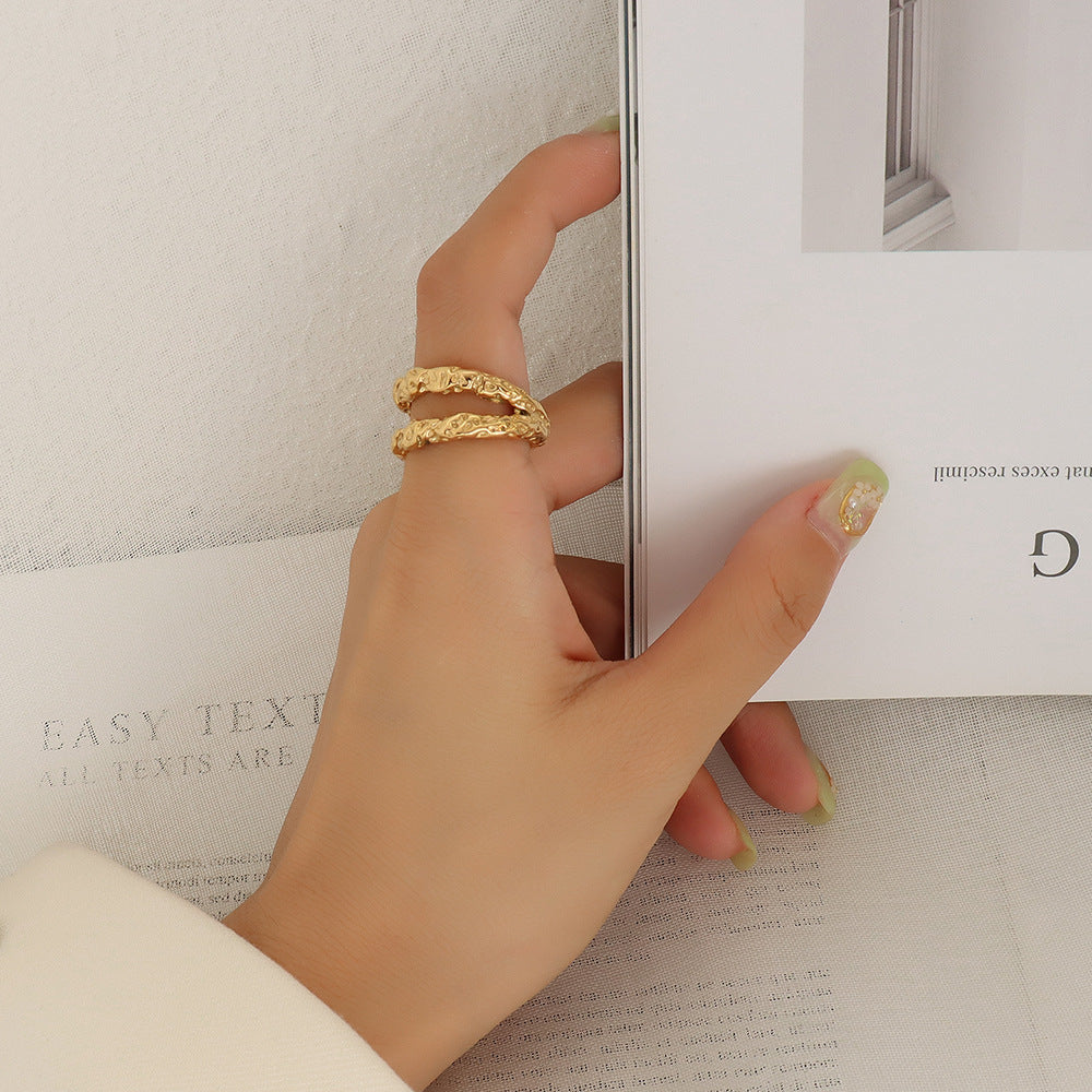 Stylish hand wearing hammered gold adjustable ring holding book – Ins style aesthetic