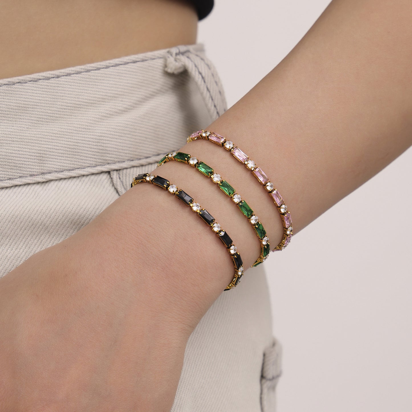 Close-up of layered beaded bracelets worn on wrist – gold clasp multicolor jewelry