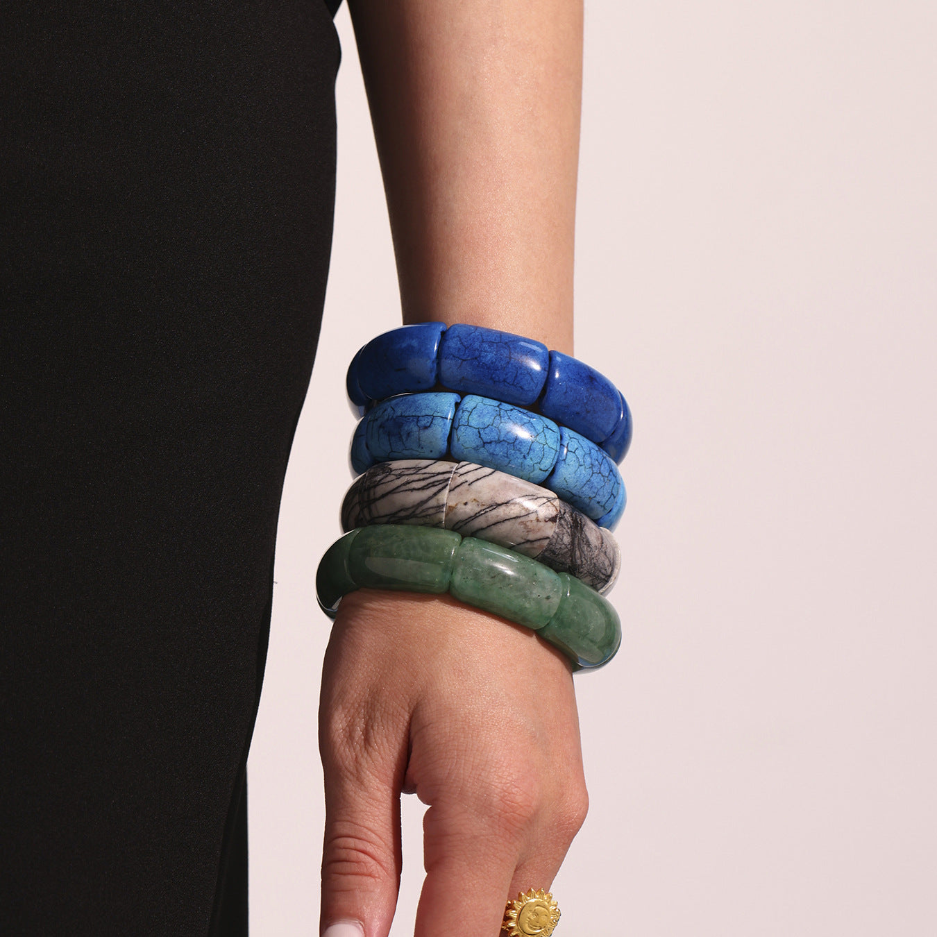 Model wearing stacked blue and green tennis bracelets – natural gemstone stretch style