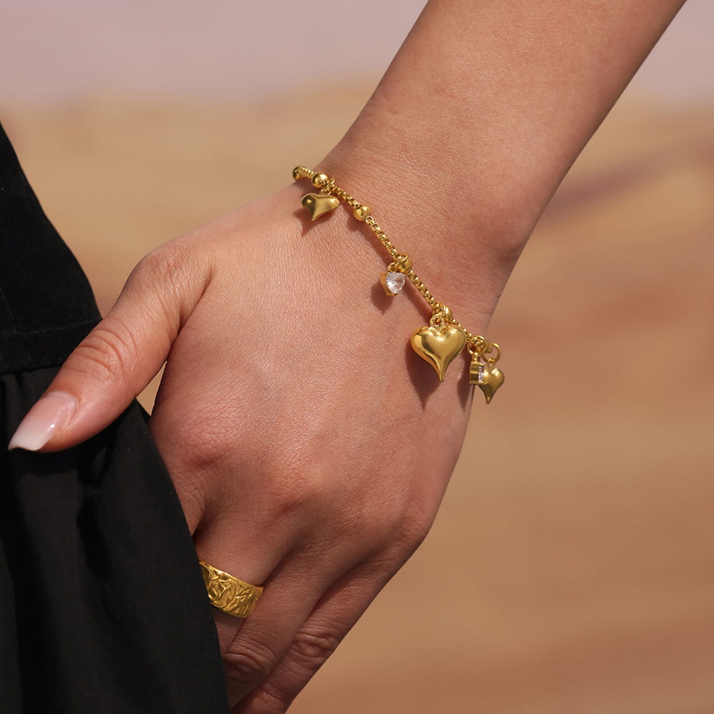 Zircon Heart Charm Tennis Bracelet resting on black velvet, highlighting luxury and elegant design