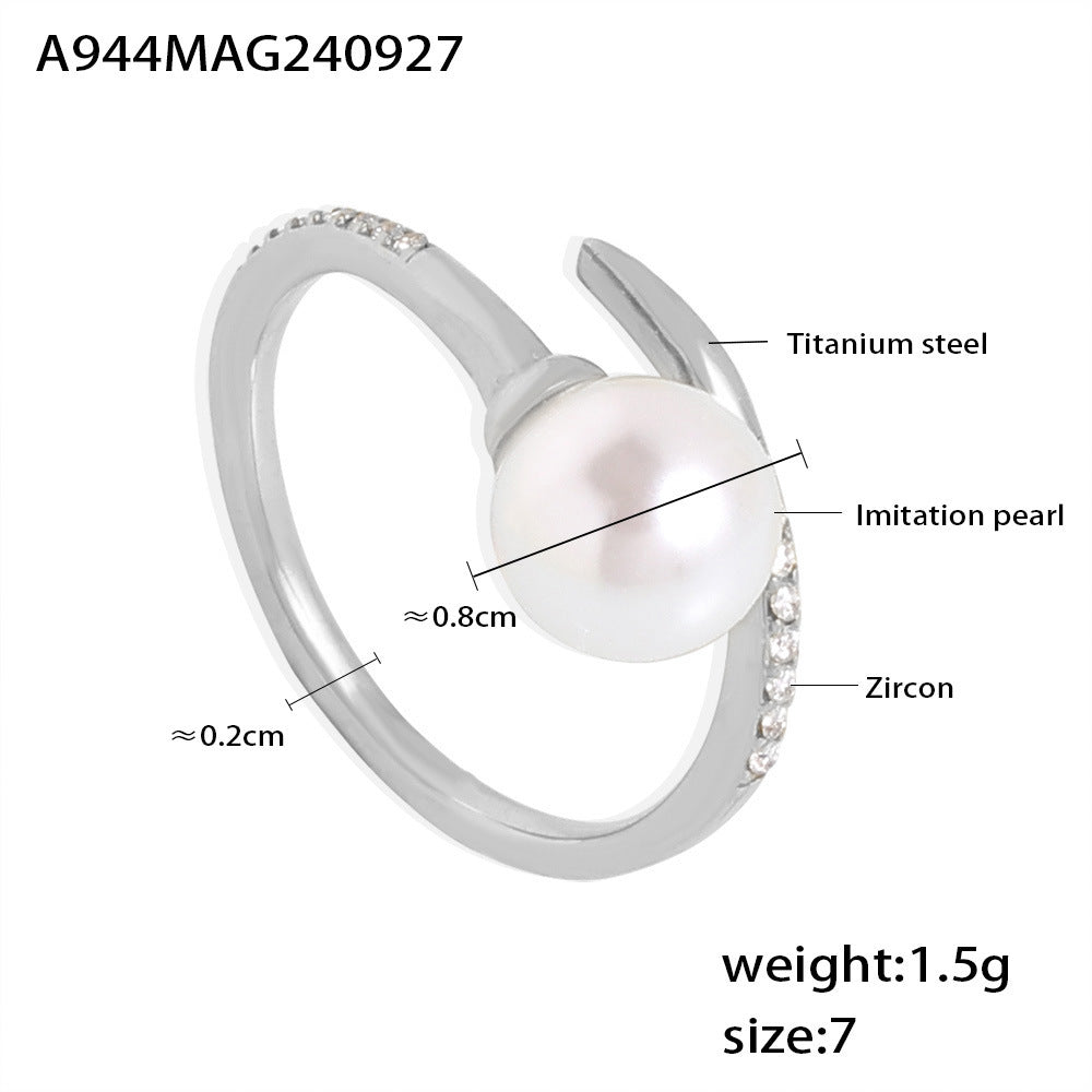 Minimalist gold-plated stainless steel ring with pearl and zircon stones displayed on a white surface