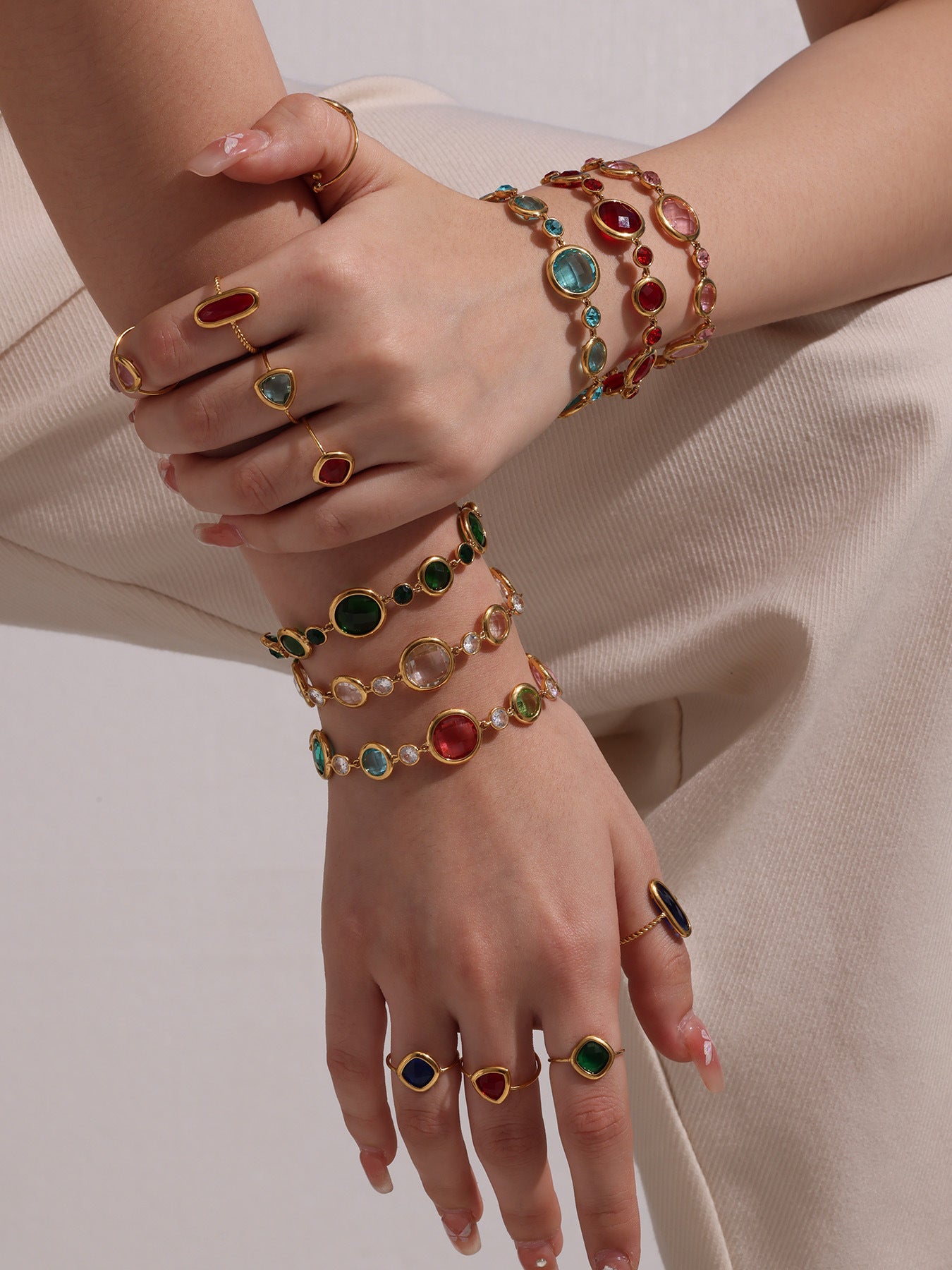 Model in white outfit wearing colorful Czech glass bracelets