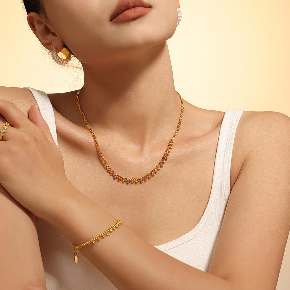 Model wearing gold beaded tassel necklace and bracelet set – minimalist styling