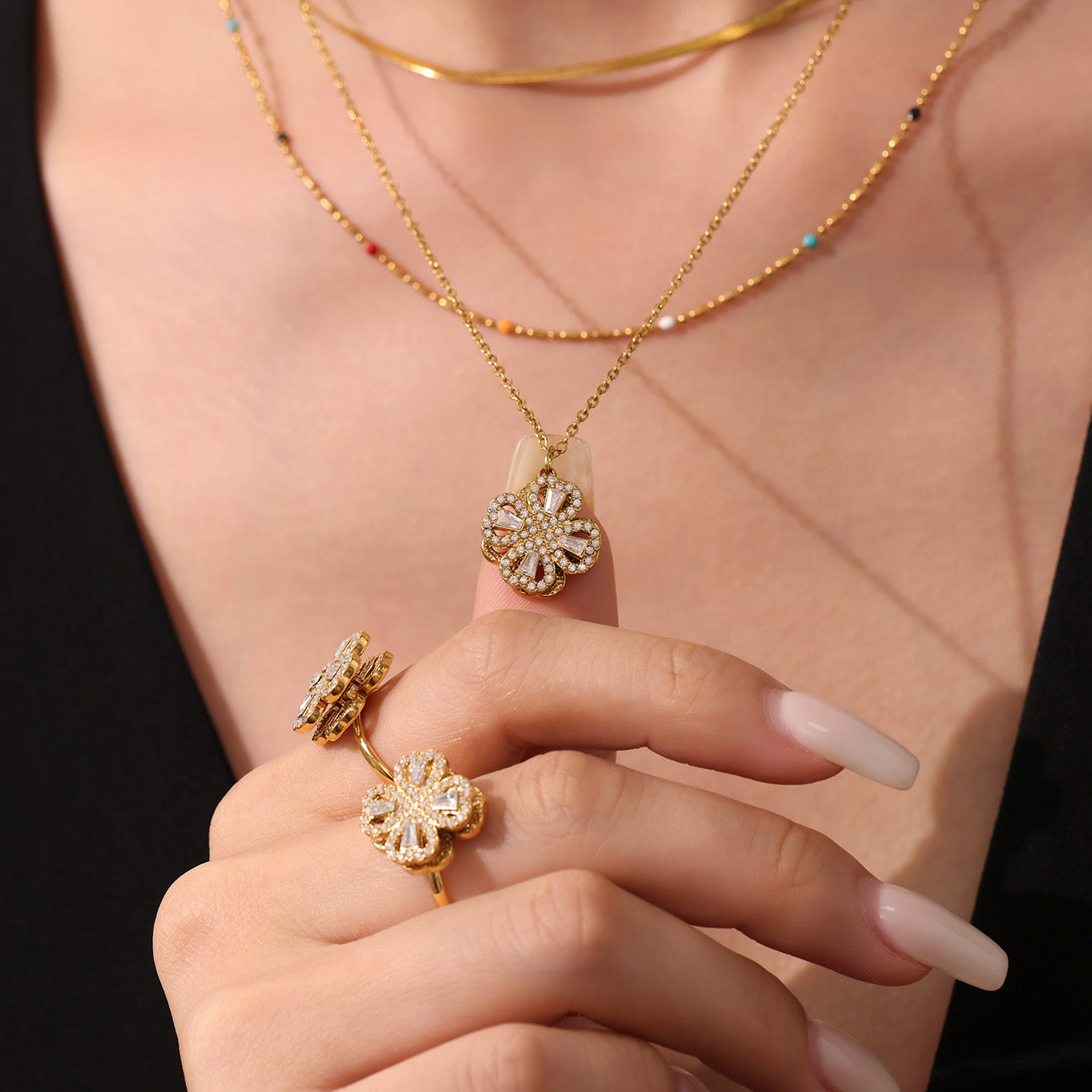 Model wearing gold rotating flower cubic zirconia necklace – dainty and stylish