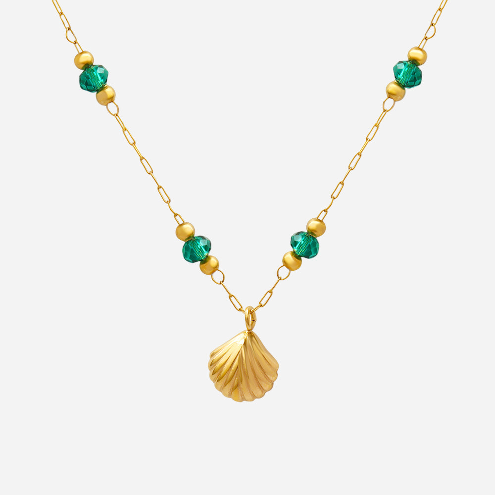 Gold necklace with green and gold beads on a white background