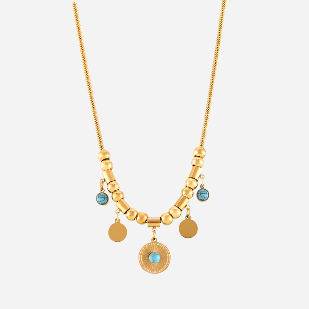 Gold necklace with blue gemstones on a white background