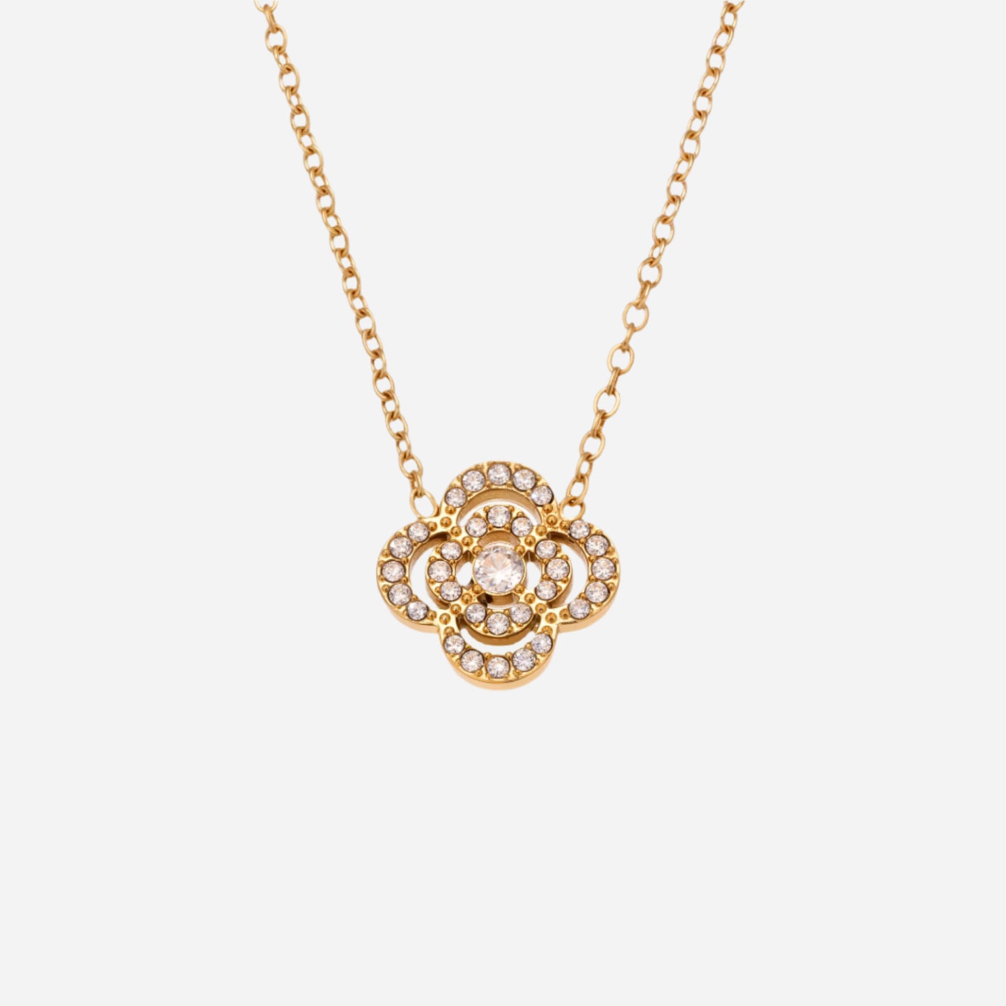 Gold necklace with a floral pendant on a white background