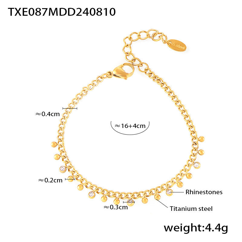 Gold bracelet with measurements and details on a white background