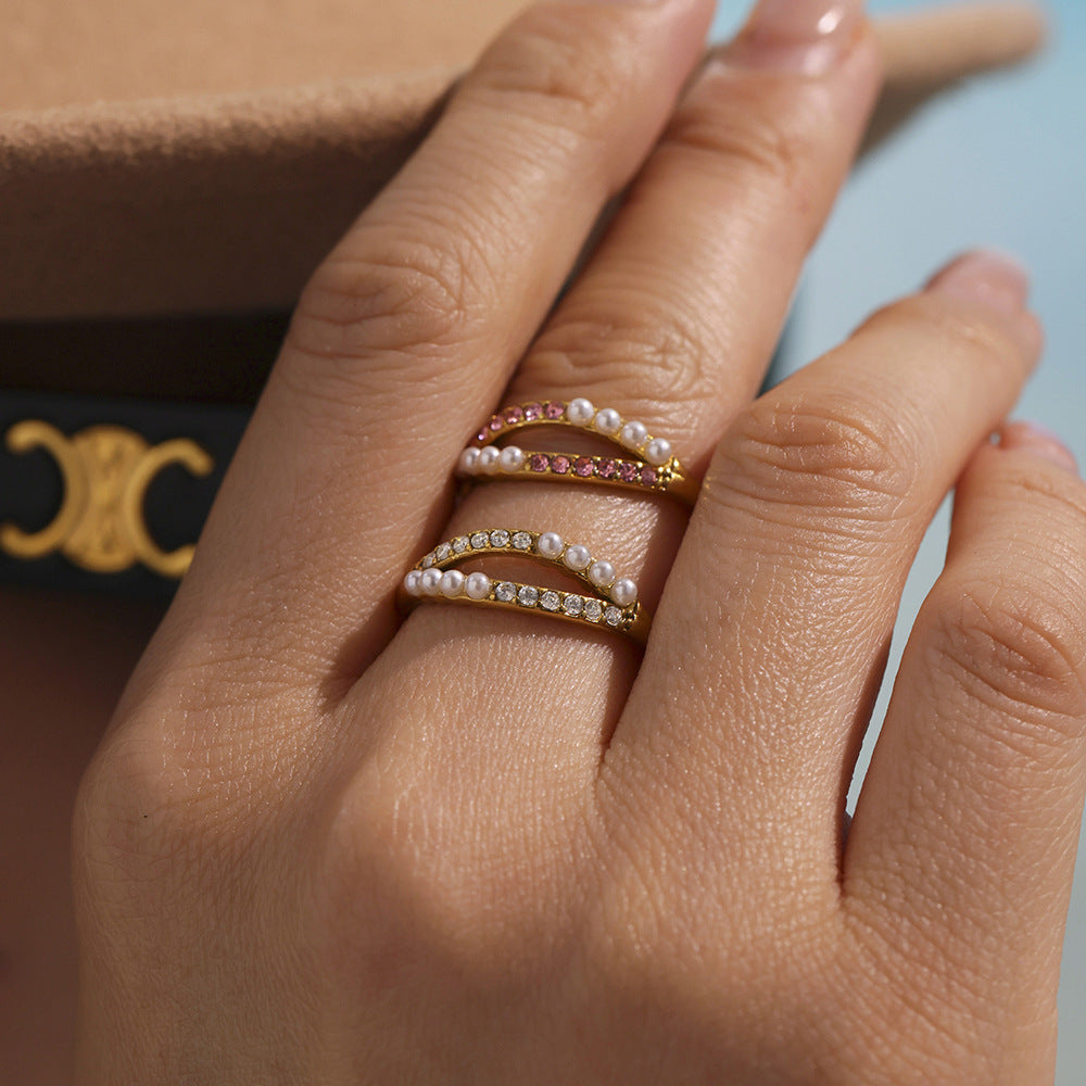 Hand styling trendy INS pearl ring with zirconia stones while holding glass