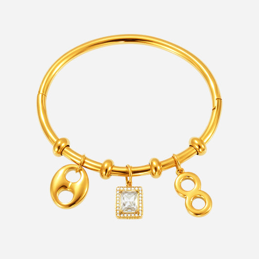 A gold-colored geometric hollow pendant bangle bracelet with a cubic zirconia accent.
