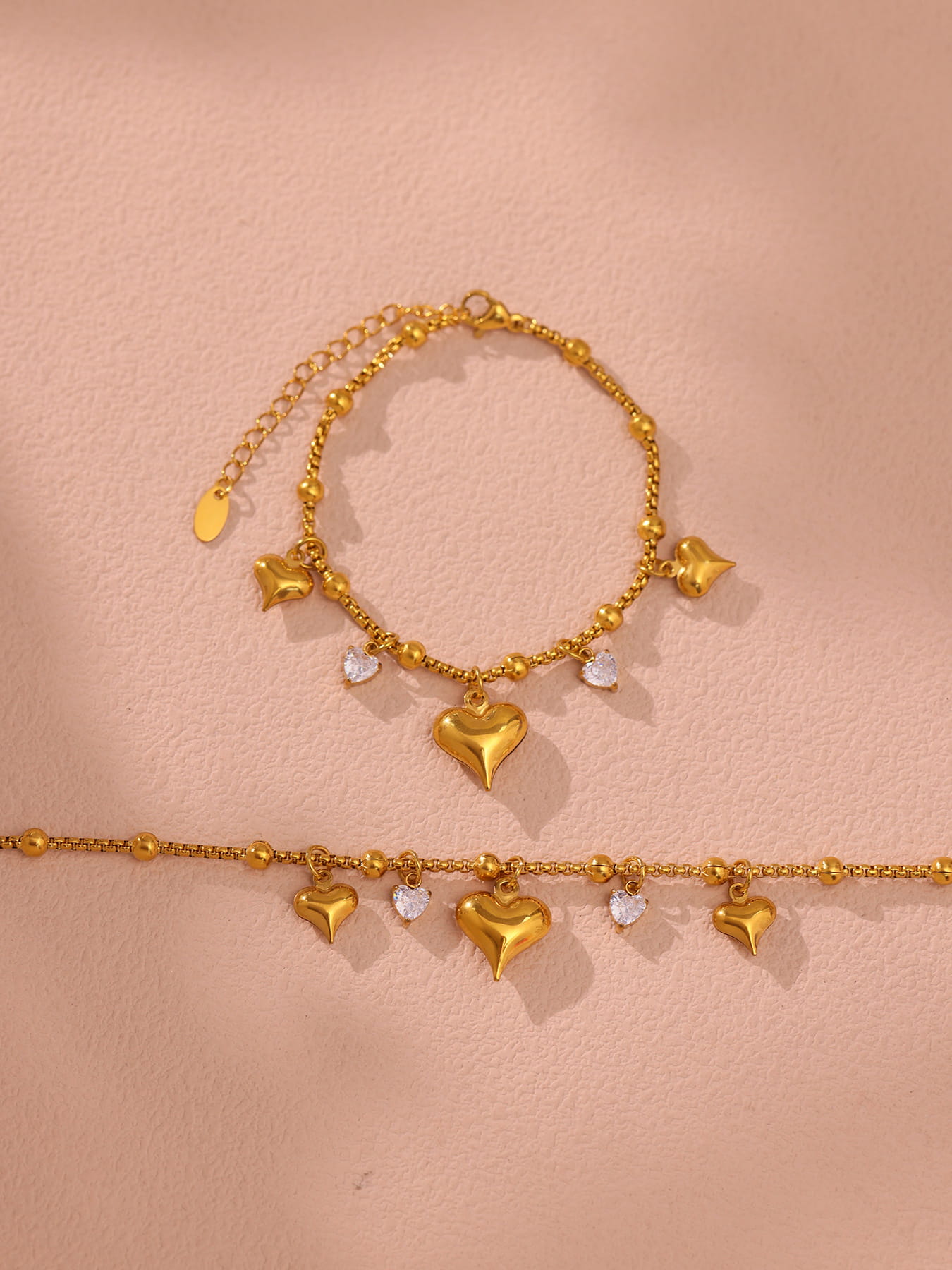Zircon heart pendant sparkling under light on silver tennis bracelet, detailed jewelry close-up