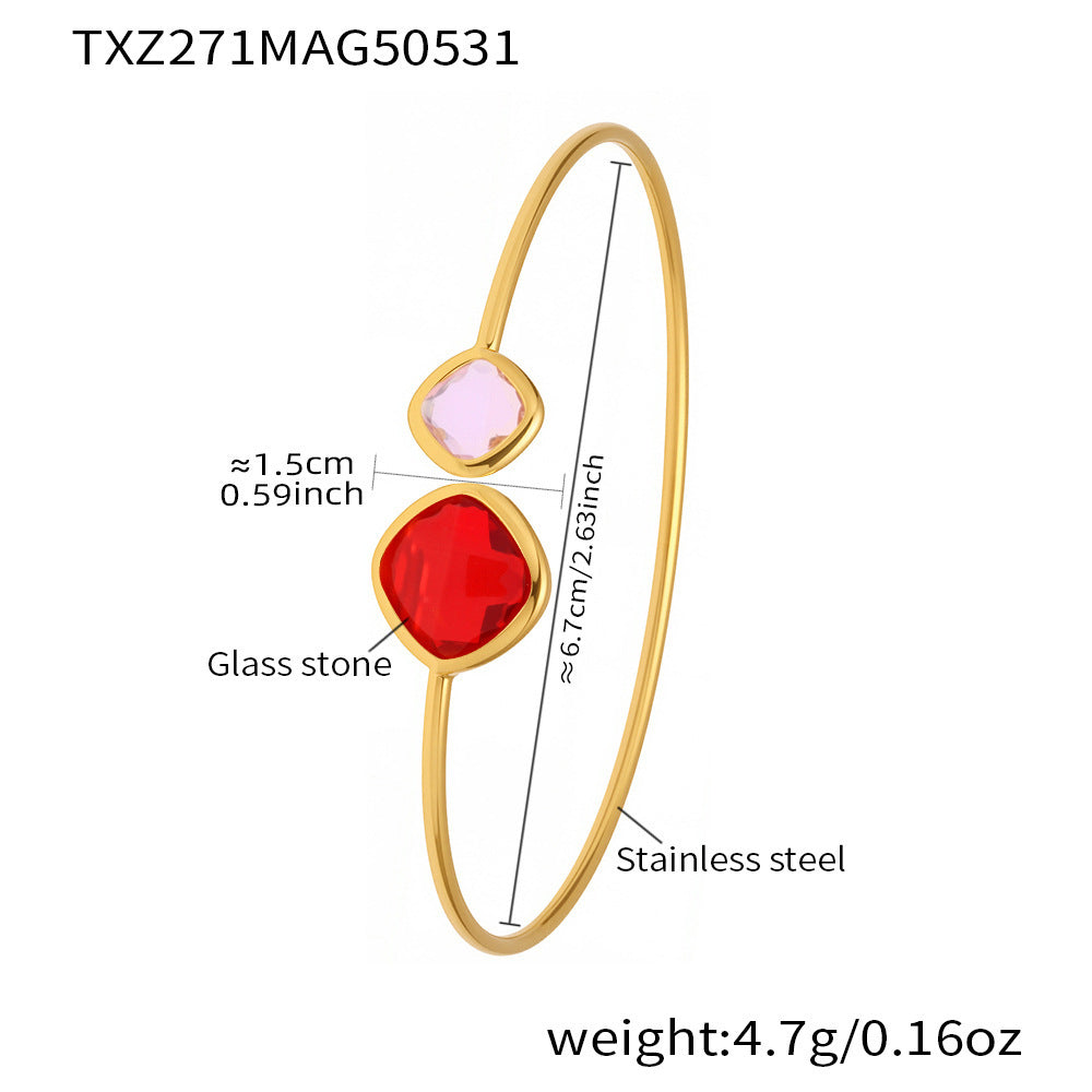 Gold bracelet with red and pink glass stones and measurements on a white background