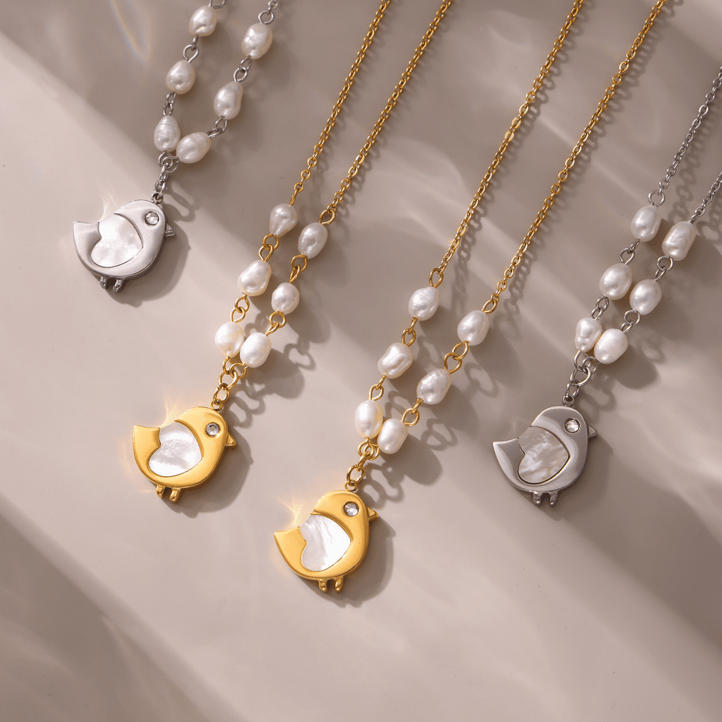 Gold and Steel Shell Chick Freshwater Pearl Necklaces Displayed in Lifestyle Scene