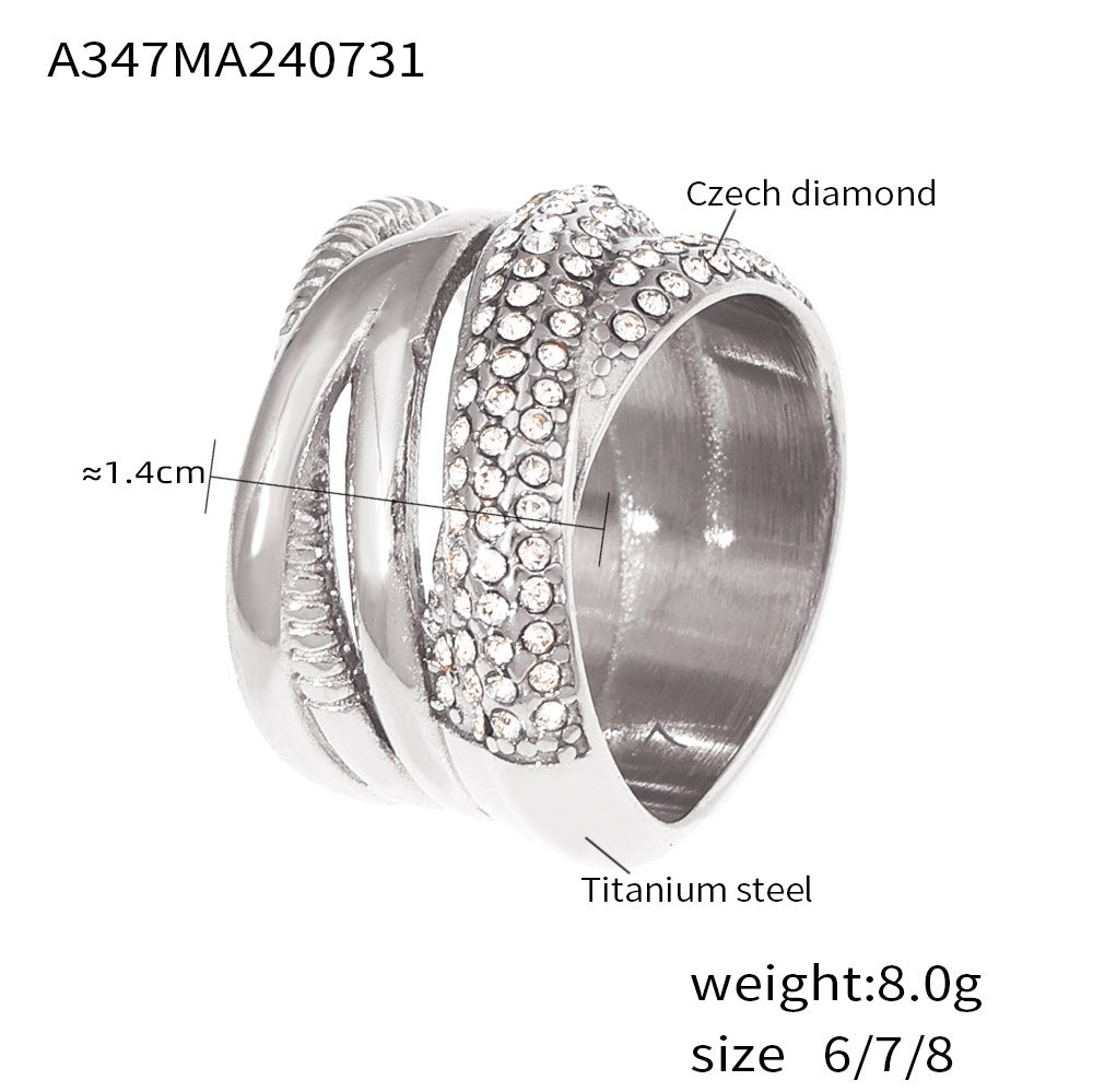 Silver ring with diamond accents on a white background