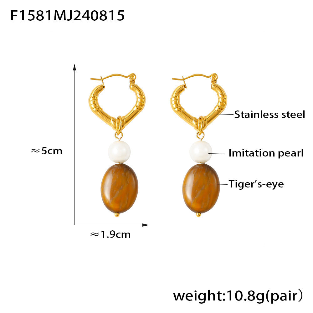 Gold hoop earrings with brown stones and white beads on a white background
