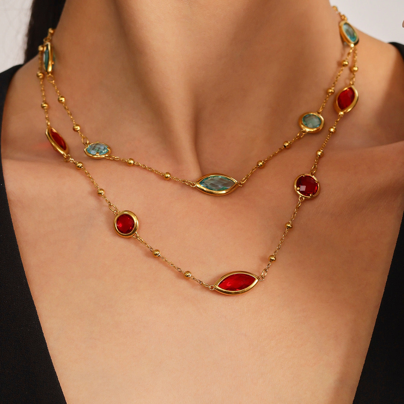 Close-up of red and green sea glass necklaces on model neck