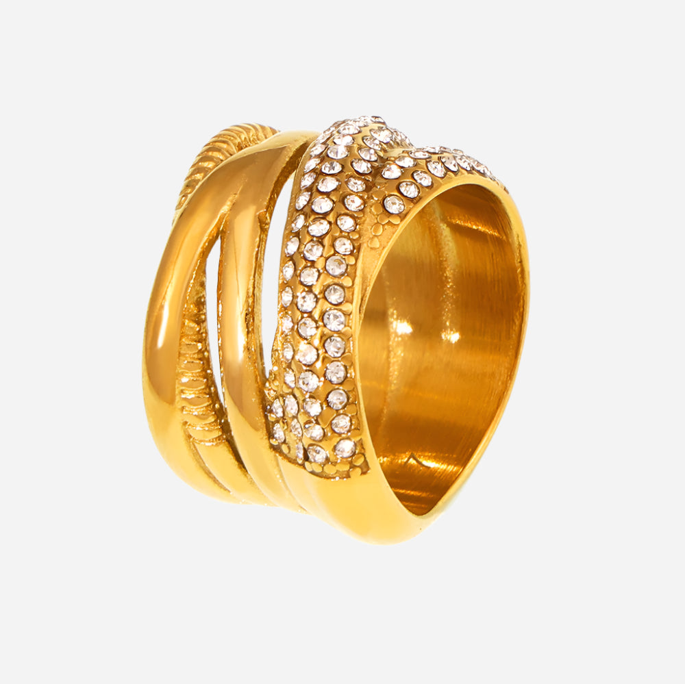Gold ring with diamond-studded design on a white background