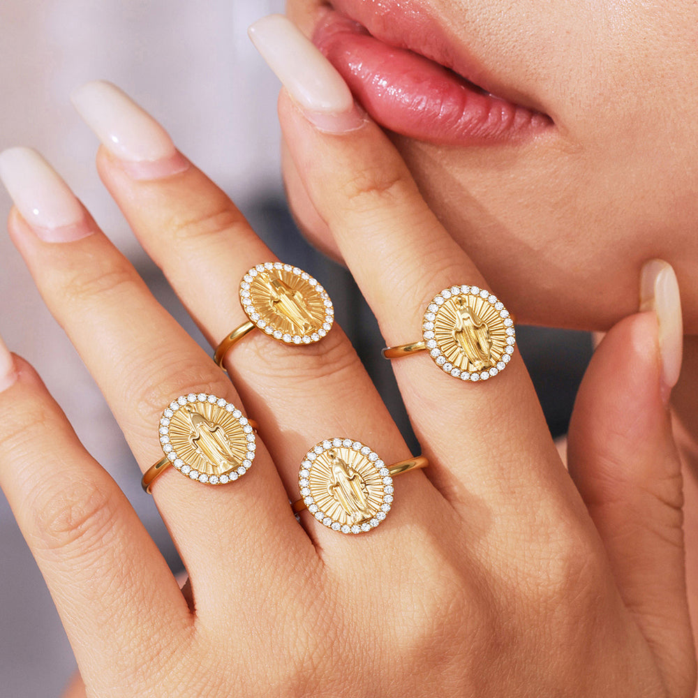 Gold rings with circular designs on a hand