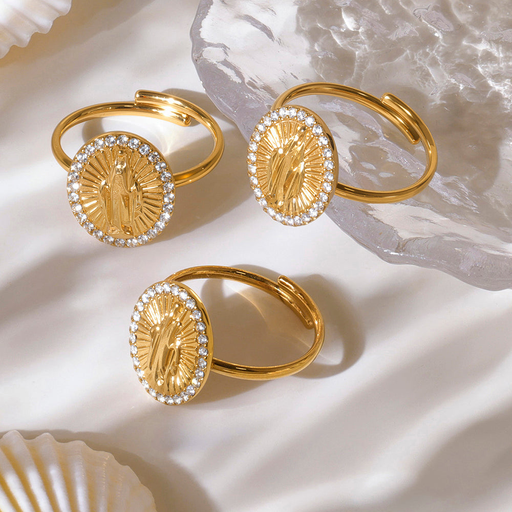 Gold hoop earrings with circular designs on a light background