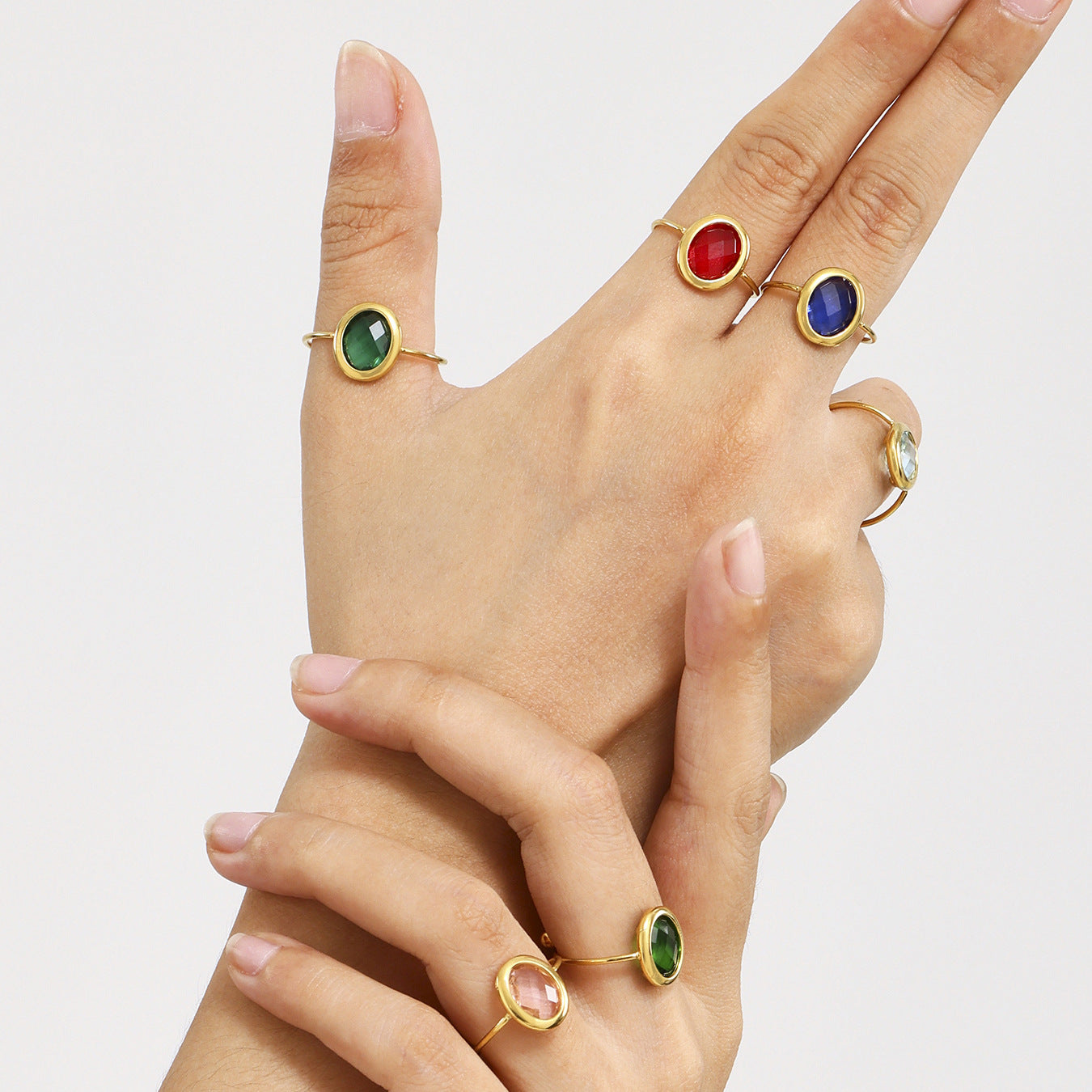 Hand modeling multiple sea glass rings with stainless steel bands
