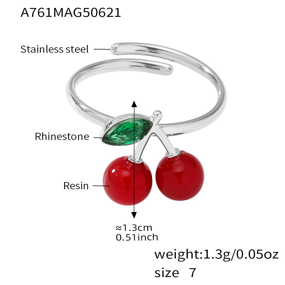 Silver cherry sea glass ring with red and green rhinestones, labeled for material