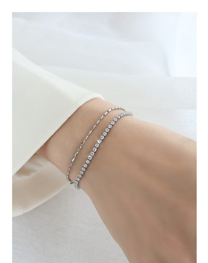 Silver stainless steel bracelet worn on wrist – minimalist waterproof design on white background