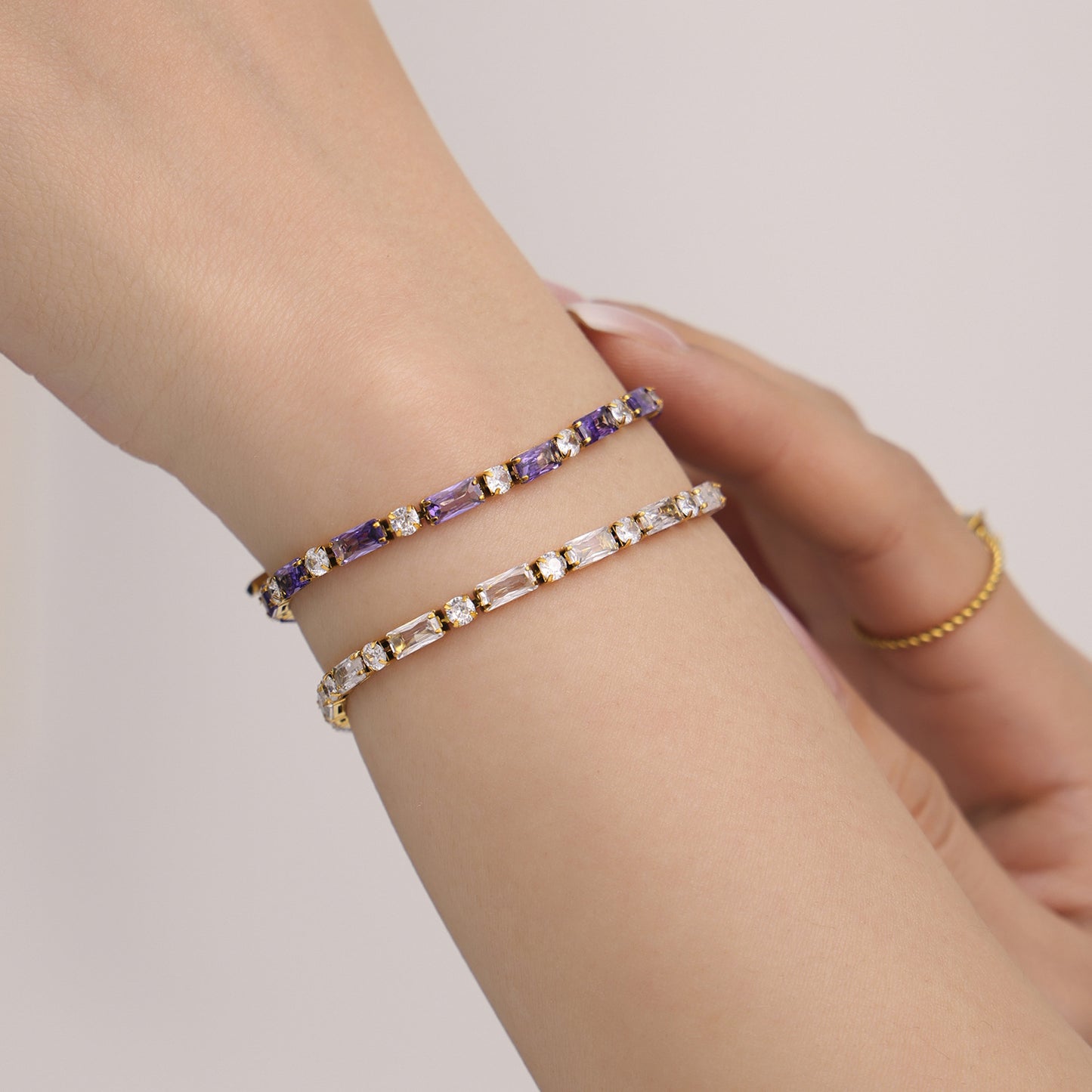 Minimalist gold and beaded bracelets stacked on wrist – stainless steel with gemstones