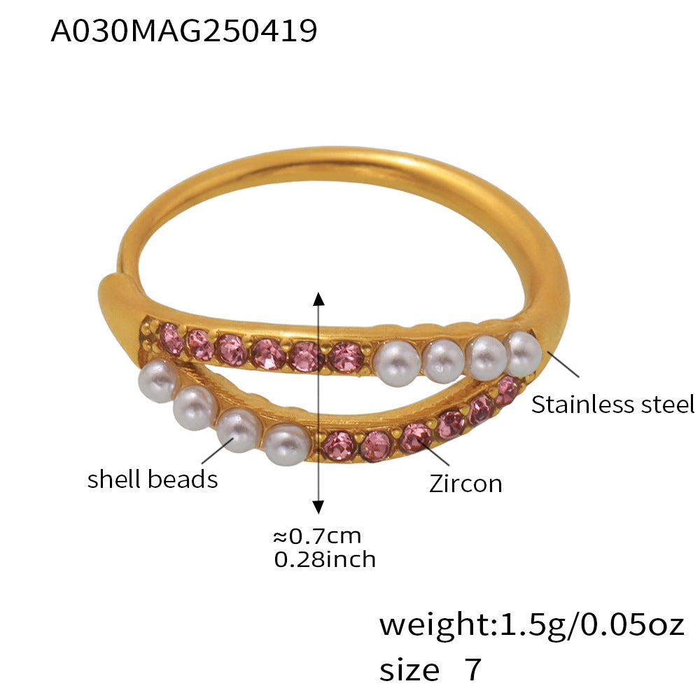 Woman wearing layered pearl and zirconia rings for chic stacking style