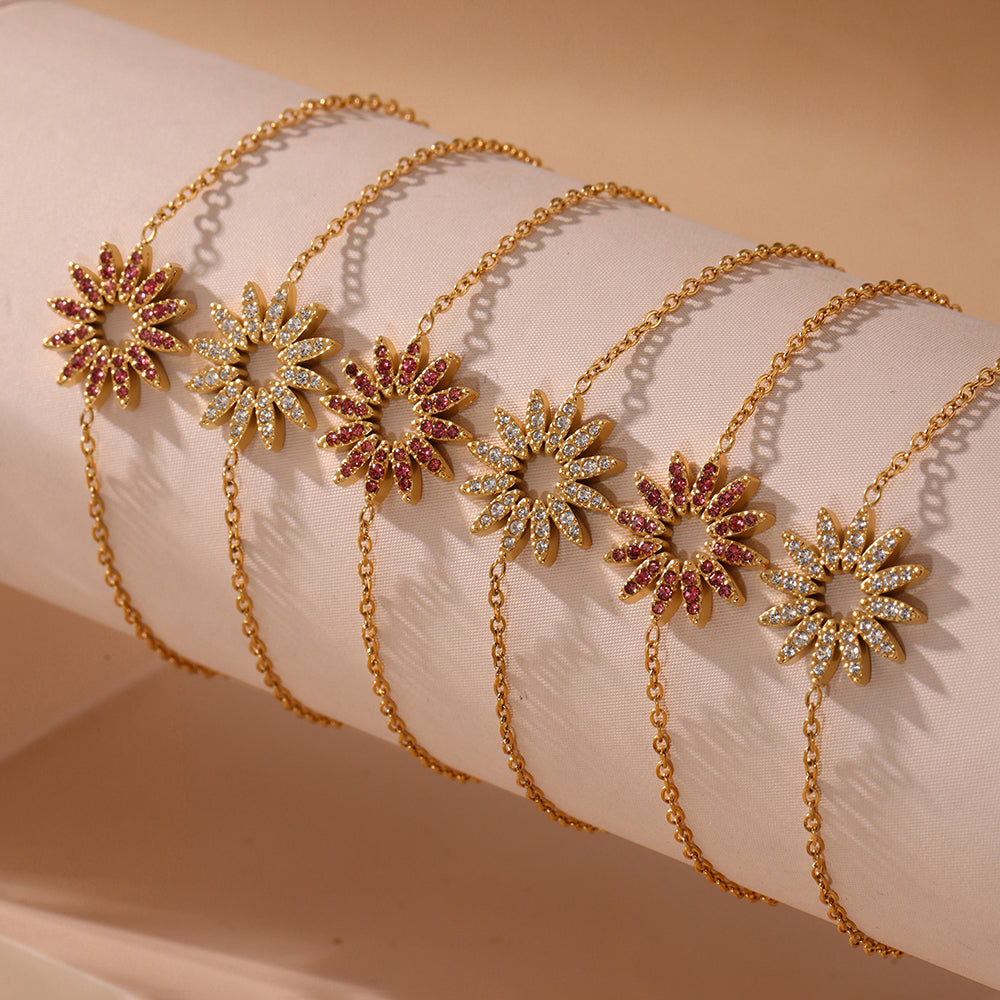 Floral gold tennis bracelet with zircon accents on beige surface