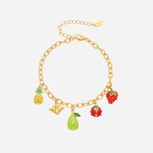 Gold bracelet with colorful fruit charms on a white background