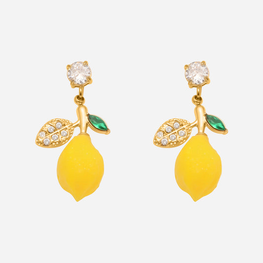 Pair of lemon-shaped earrings with gold leaves and green stones on a white background