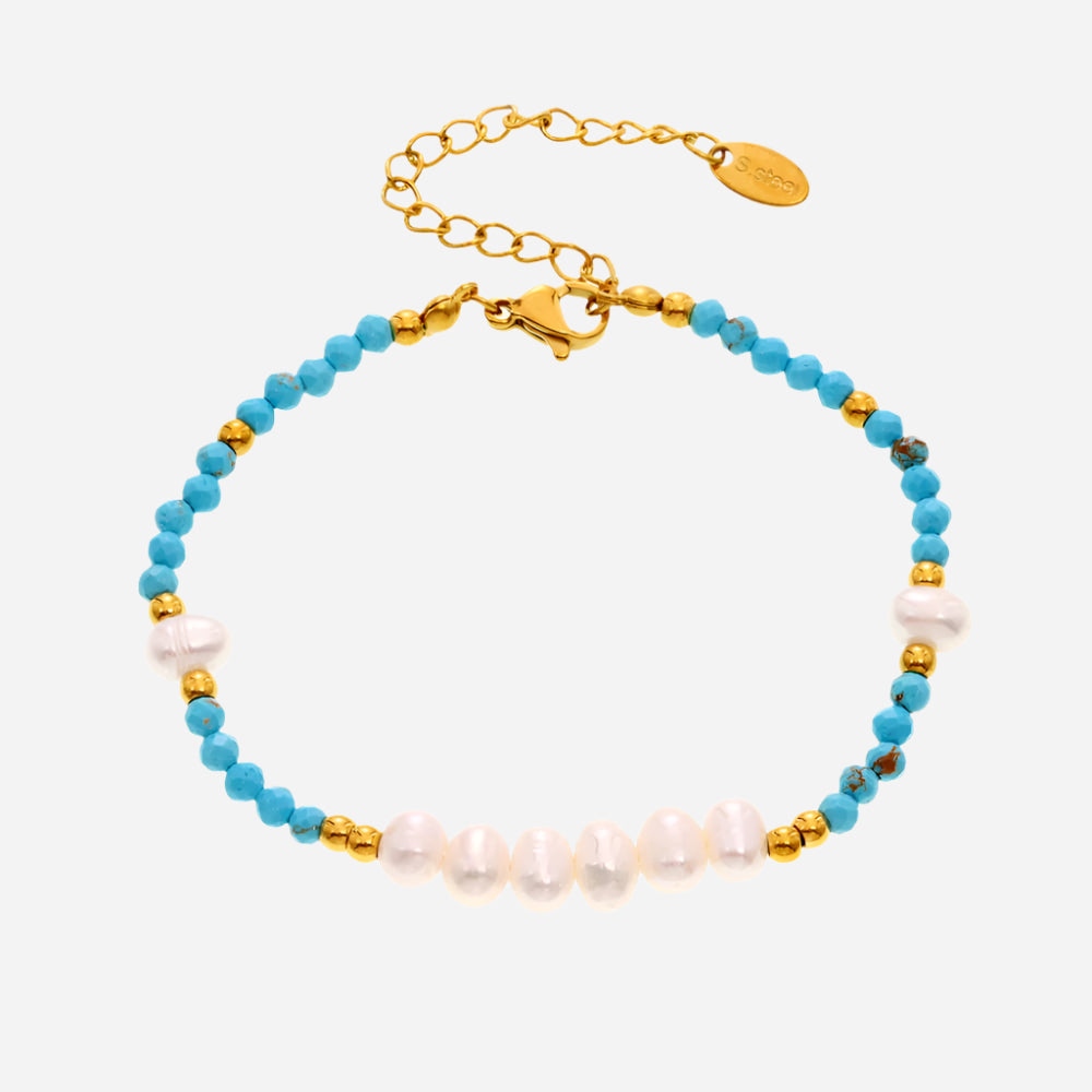 White background view of handmade turquoise and freshwater pearl beaded bracelet