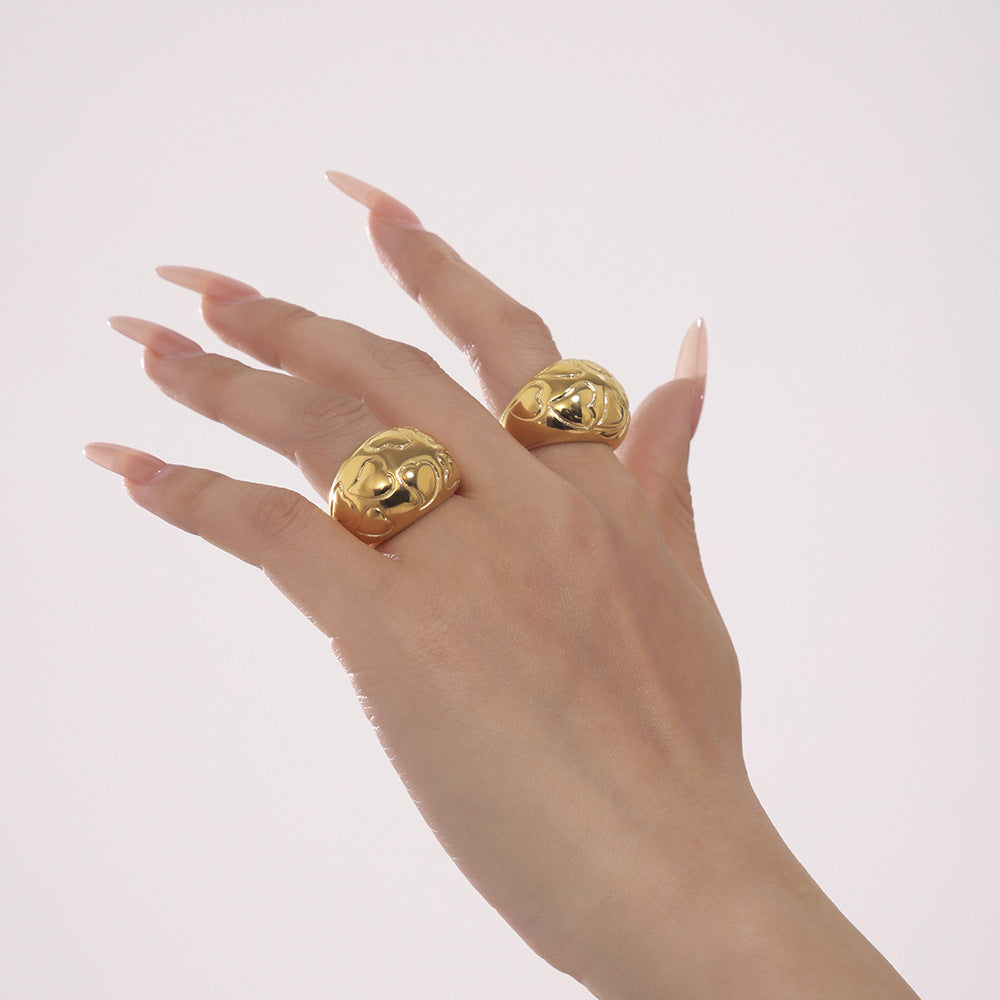 Hand wearing two adjustable gold rings – minimalist design on light background